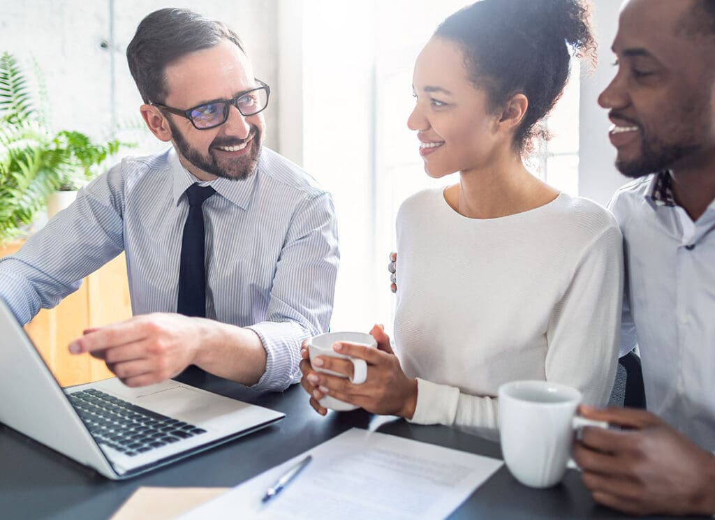 Service-Center-Family-Drinking-Coffee-and-Going-Over-Policy-Options-with-Insurance-Agent